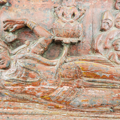 Antique heavily carved Buddhist panel with an old and original red painted surface